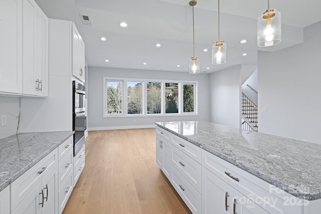 kitchen featuring white cabinets and pendant lighting