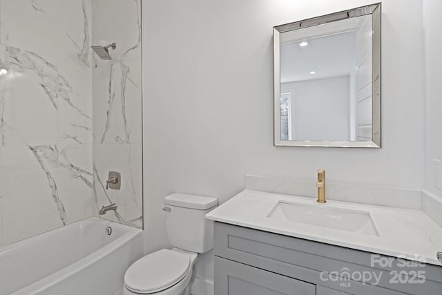 full bathroom with toilet, vanity, and tiled shower / bath