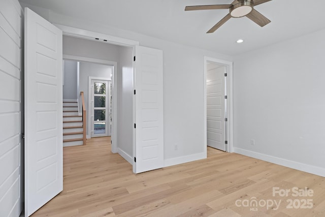 unfurnished bedroom featuring ceiling fan and light hardwood / wood-style flooring