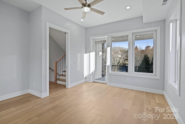 spare room featuring ceiling fan and light wood-type flooring