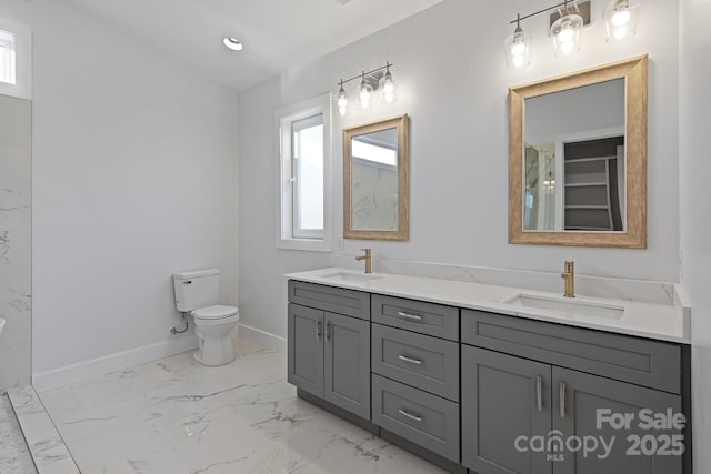 bathroom featuring vanity, toilet, and a wealth of natural light