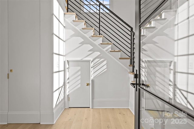 stairs with hardwood / wood-style flooring