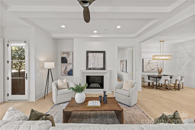 living room featuring ceiling fan and wood-type flooring