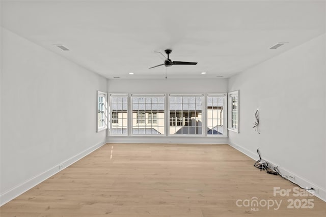 spare room featuring ceiling fan and light hardwood / wood-style floors