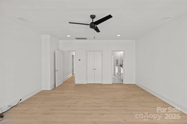 unfurnished bedroom with ceiling fan, light hardwood / wood-style floors, and a closet