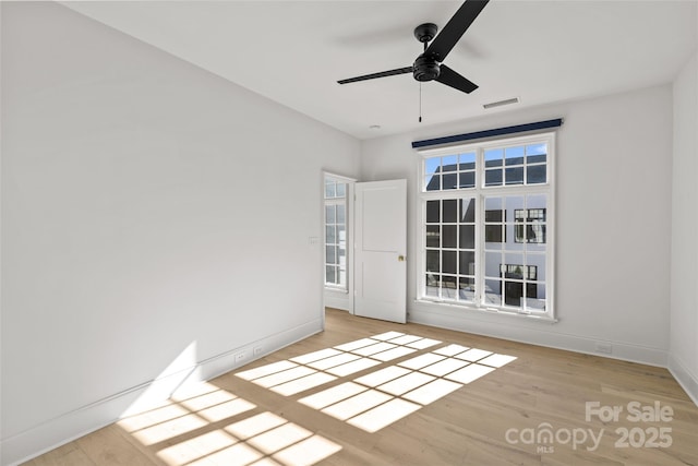 empty room featuring ceiling fan and light hardwood / wood-style floors