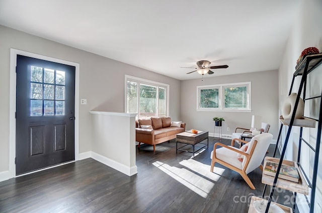 interior space featuring ceiling fan, a wealth of natural light, and dark hardwood / wood-style flooring