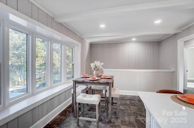 dining room with beamed ceiling and plenty of natural light