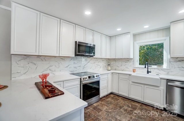 kitchen featuring stainless steel appliances, sink, and white cabinets