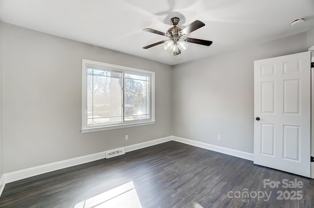 empty room featuring dark hardwood / wood-style floors and ceiling fan