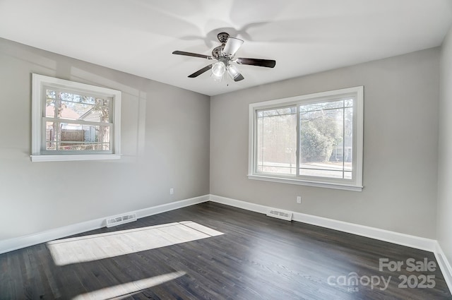 unfurnished room with dark wood-type flooring and ceiling fan