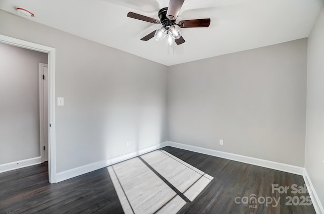 empty room with dark hardwood / wood-style flooring and ceiling fan