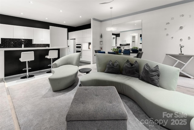 living room featuring sink and ornamental molding