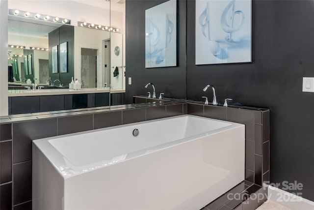 bathroom with vanity and a bathing tub