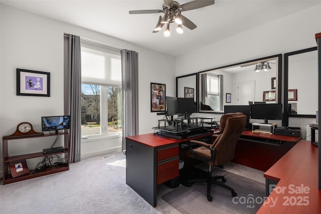 carpeted home office featuring ceiling fan