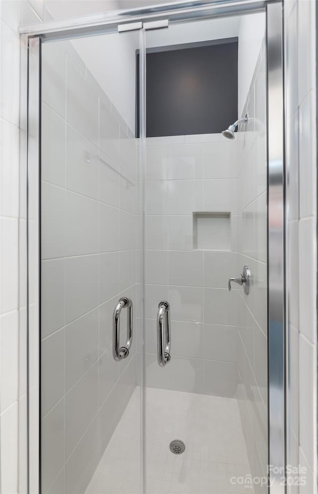 bathroom with a shower with door