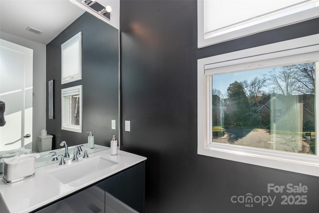 bathroom featuring vanity and toilet