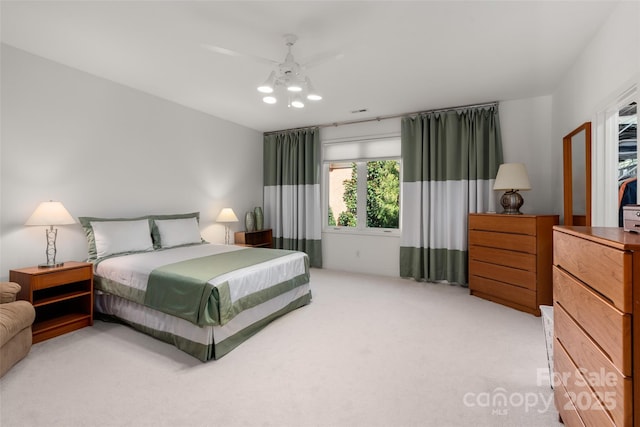 bedroom featuring light colored carpet and ceiling fan