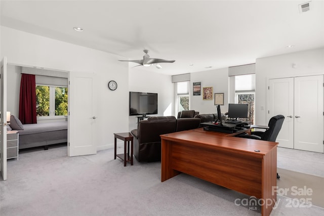 carpeted office featuring ceiling fan