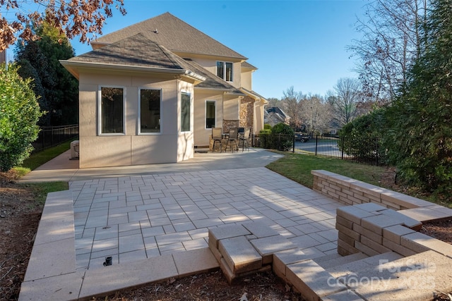 rear view of property featuring a patio area