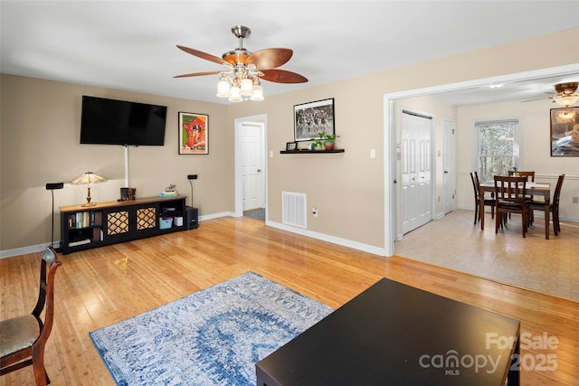 living room featuring ceiling fan and wood-type flooring