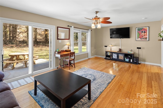 living room featuring ceiling fan and light hardwood / wood-style flooring