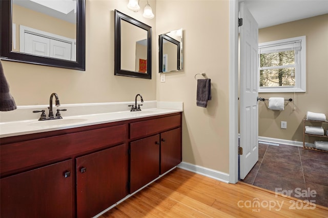 bathroom with hardwood / wood-style floors and vanity