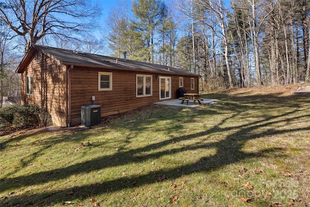 back of house with a patio area, central AC, and a yard