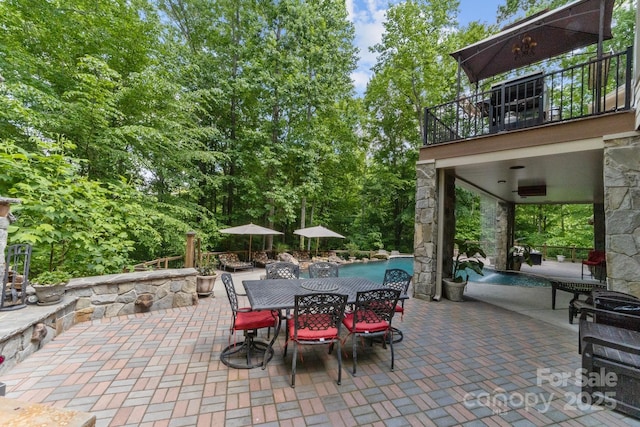 view of patio featuring a balcony