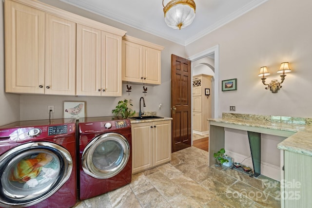 laundry area featuring sink, crown molding, cabinets, and independent washer and dryer