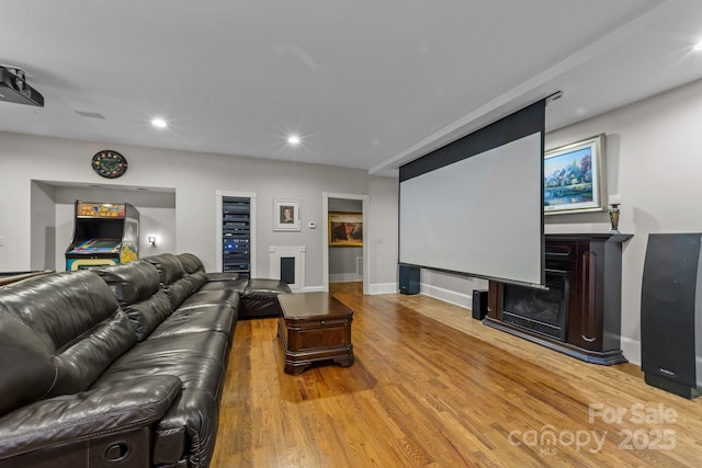 home theater featuring a fireplace and hardwood / wood-style flooring