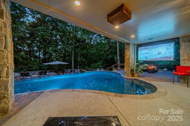 view of swimming pool with a patio area and an outdoor hangout area