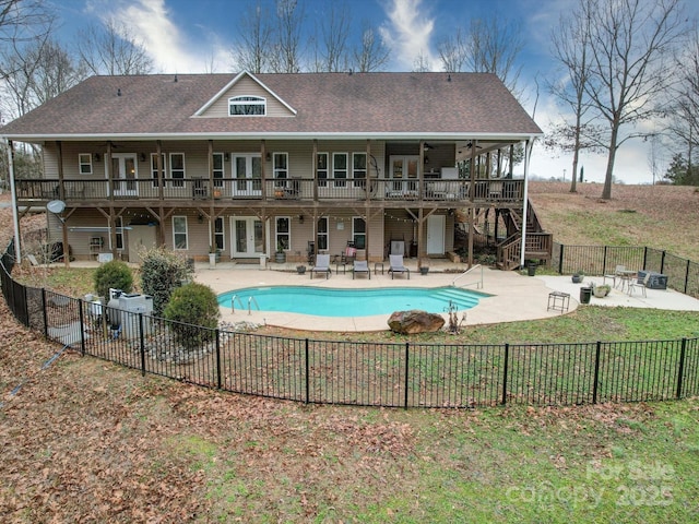 view of pool featuring french doors, ceiling fan, and a patio area