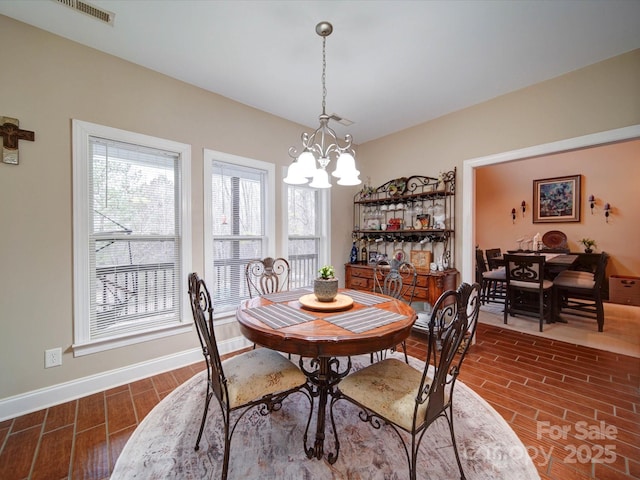 dining area with an inviting chandelier