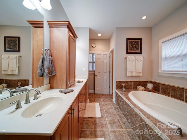 bathroom featuring vanity and tiled bath