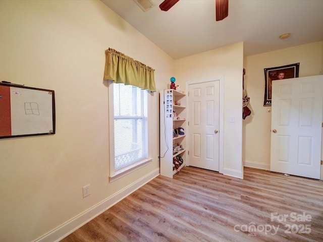 unfurnished bedroom featuring light wood-type flooring and ceiling fan