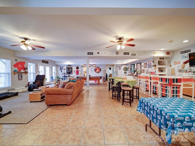 tiled living room with ceiling fan and billiards