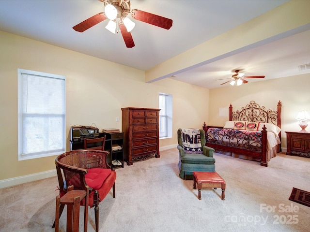 carpeted bedroom with beamed ceiling and ceiling fan