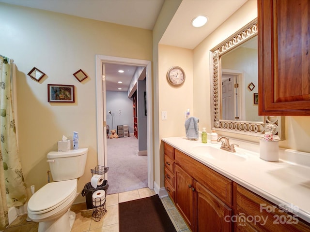 bathroom featuring tile patterned flooring, vanity, and toilet