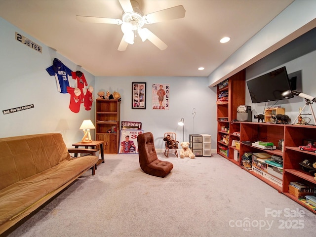 living area featuring ceiling fan and carpet floors