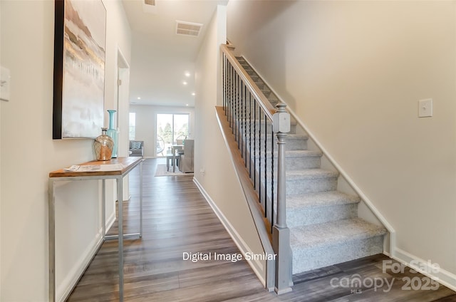 stairway featuring wood-type flooring