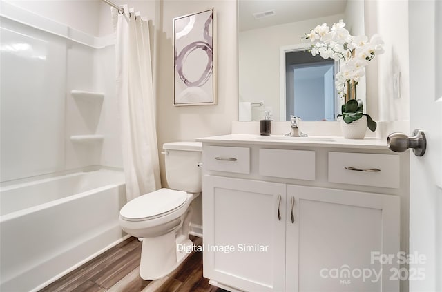 full bathroom with shower / tub combo, vanity, hardwood / wood-style flooring, and toilet