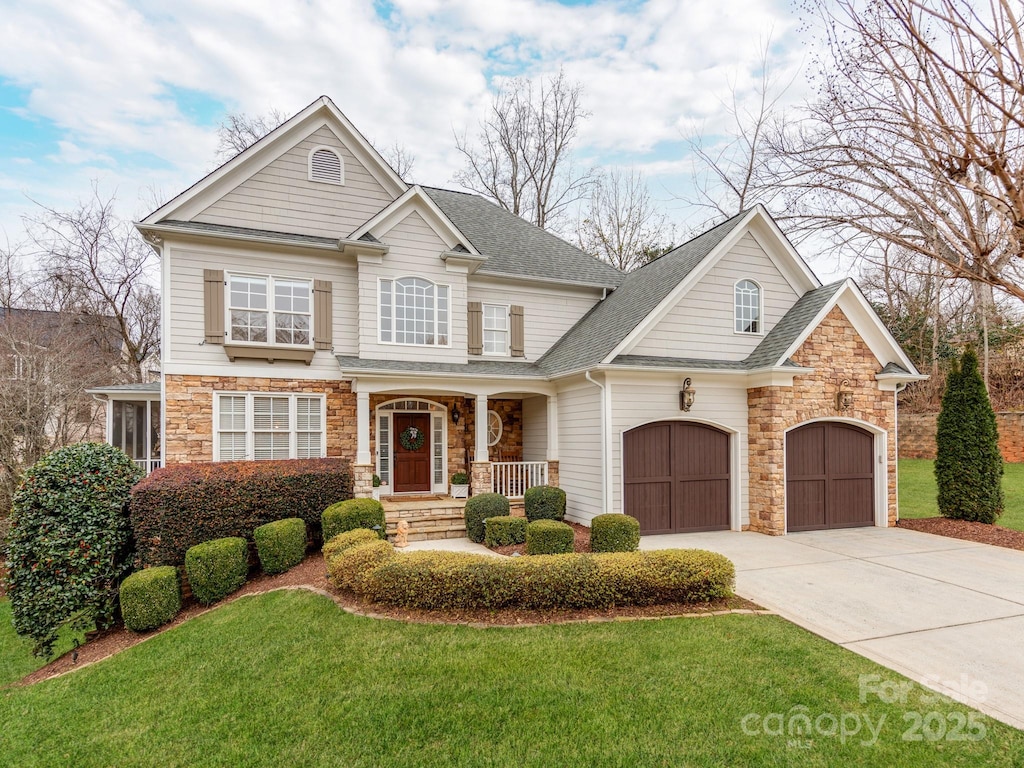 view of front of property featuring a garage and a front lawn