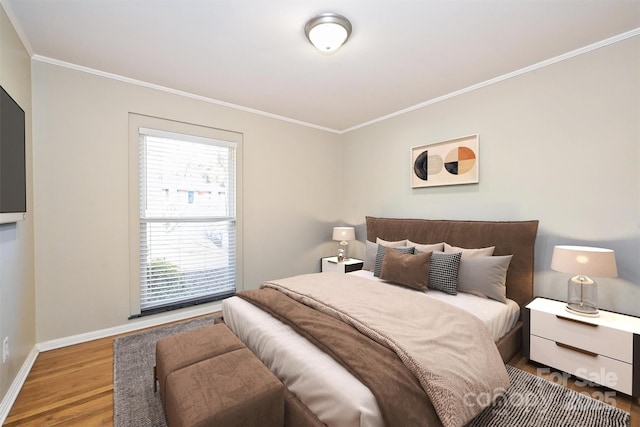 bedroom featuring hardwood / wood-style floors and ornamental molding