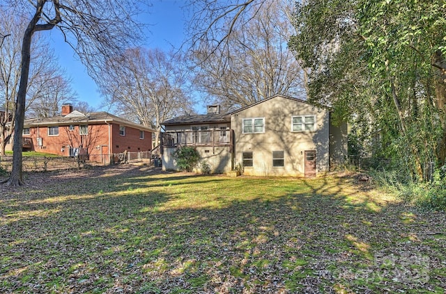 back of house with a lawn