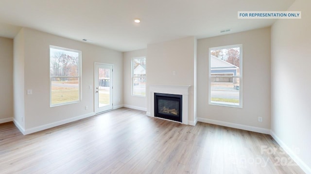 unfurnished living room with plenty of natural light and light wood-type flooring