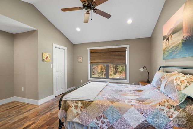 bedroom with hardwood / wood-style floors, ceiling fan, lofted ceiling, and a closet