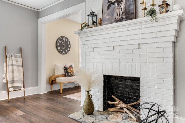 room details with hardwood / wood-style floors, a brick fireplace, and crown molding