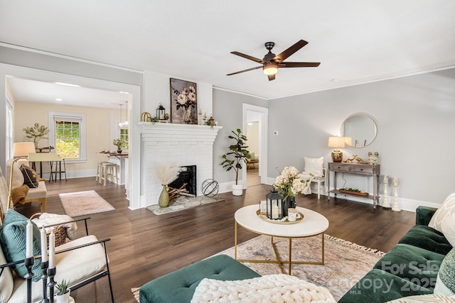 living room featuring a fireplace, dark hardwood / wood-style flooring, and ceiling fan