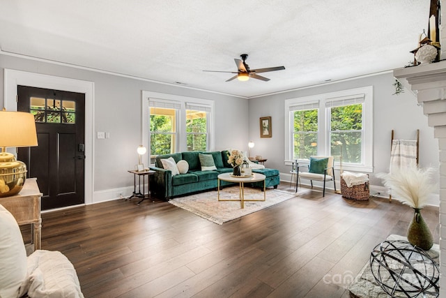 living room featuring plenty of natural light, ceiling fan, and crown molding